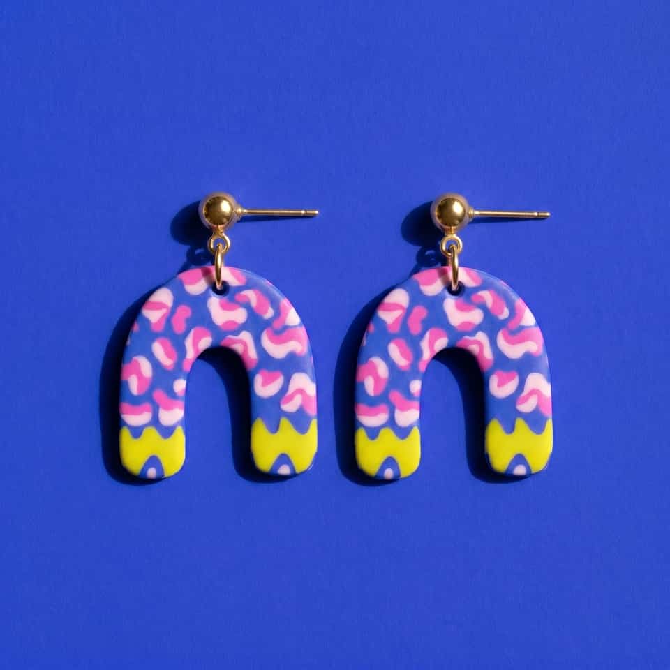 Polymer Clay Abstract Cobalt Squiggle Arch Dangle Earrings. Handmade earrings using surface applique with a gloss sealant finish. Build cobalt arch earrings from a pre-patterned s…