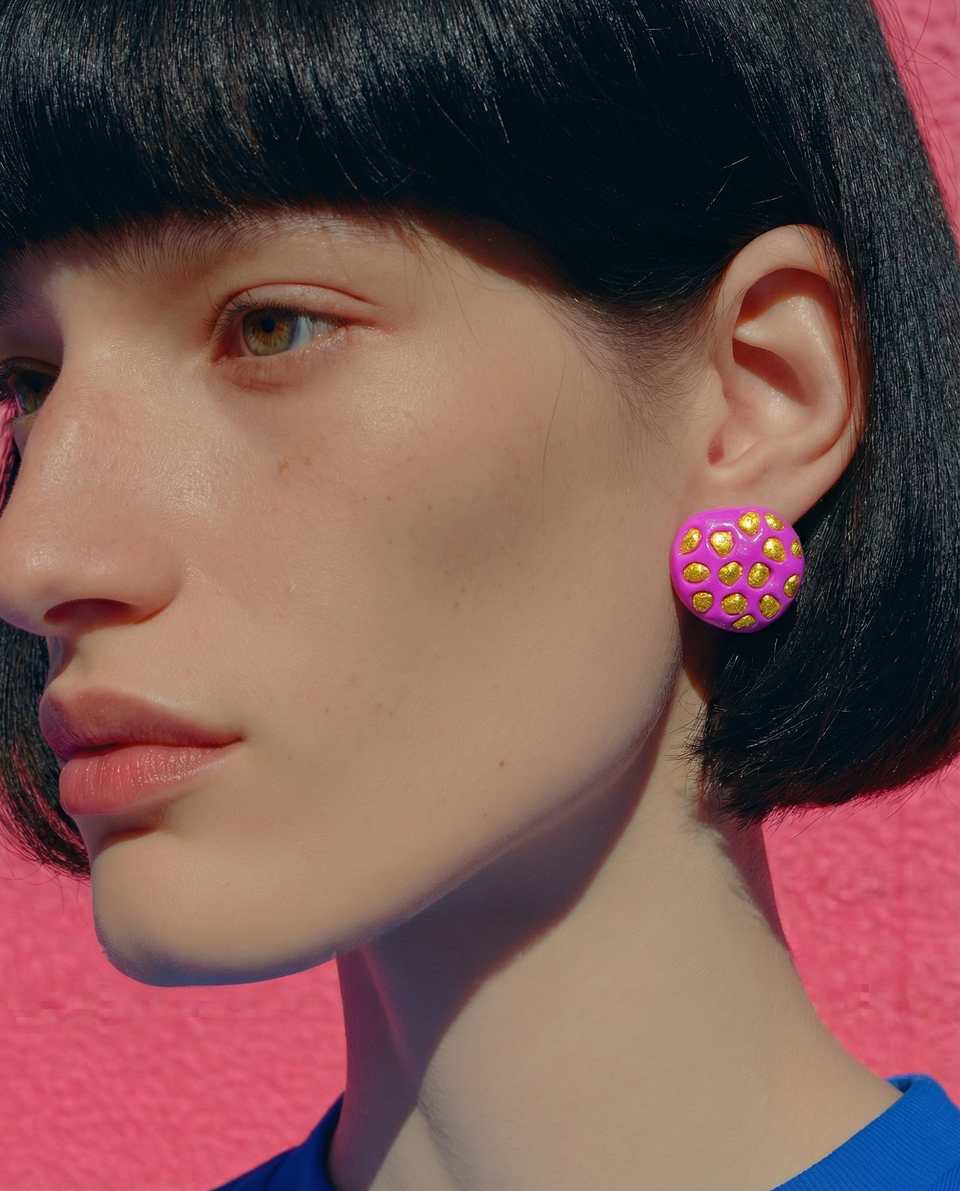 Magenta Polymer Clay Dome Studs with Gold Glitter Inlay Earrings shown in styled wear context with size, drape, and hardware visible. Surface effects earrings with a gloss sealant…