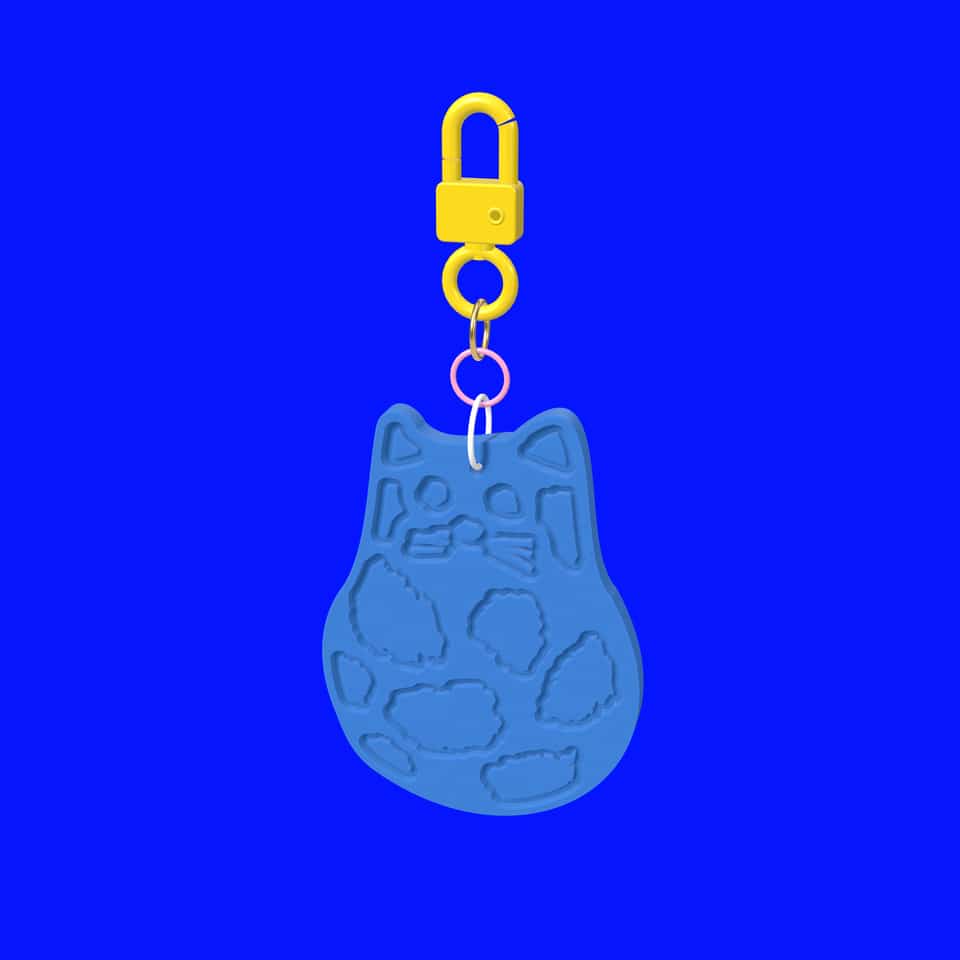 A relief cat charm hanging from a swivel clasp.
