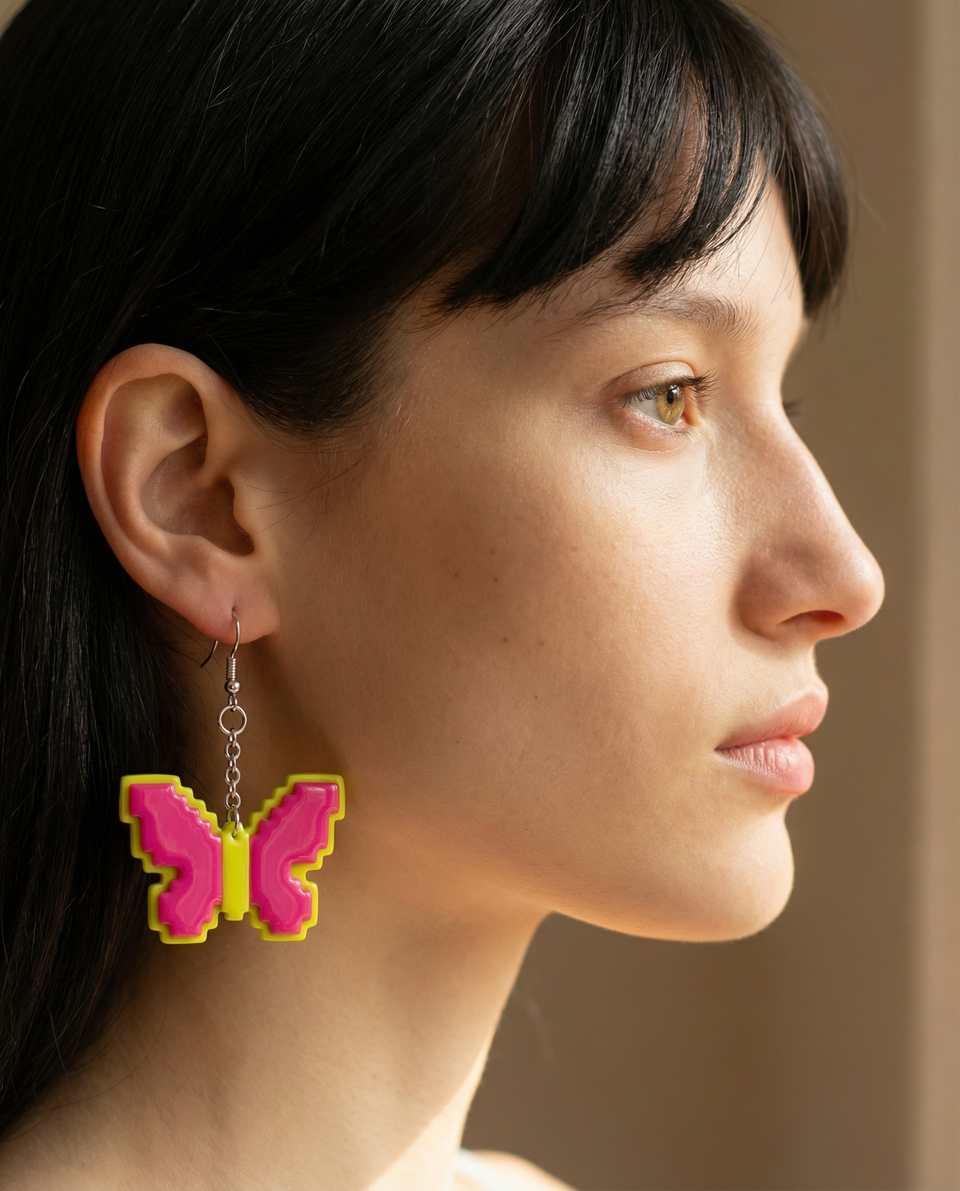 Pink Polymer Clay & Yellow Pixel Butterfly Drop Dangle Earrings shown in styled wear context with size, drape, and hardware visible. Pixel construction earrings with a gloss seala…
