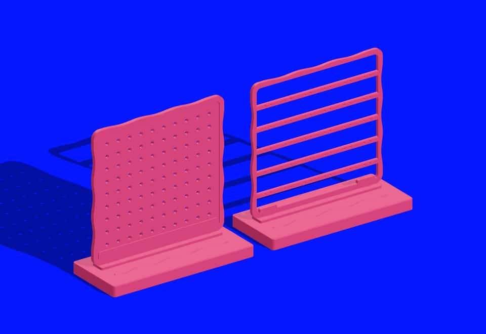 The two empty inserts seated in the shared base. Add and check your own earrings or cards.