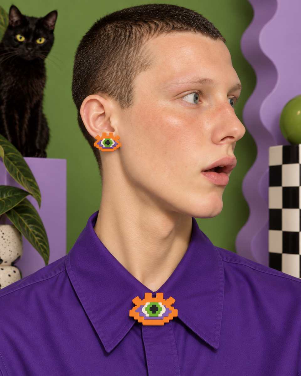 A Halloween-colour stud and a matching brooch.
