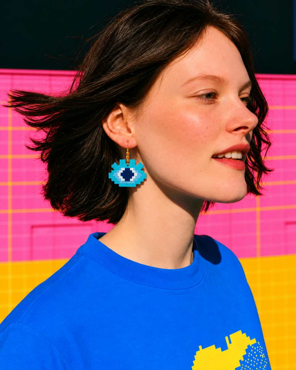 The drop earring worn in turquoise and pale blue, with a white eye and a navy centre.