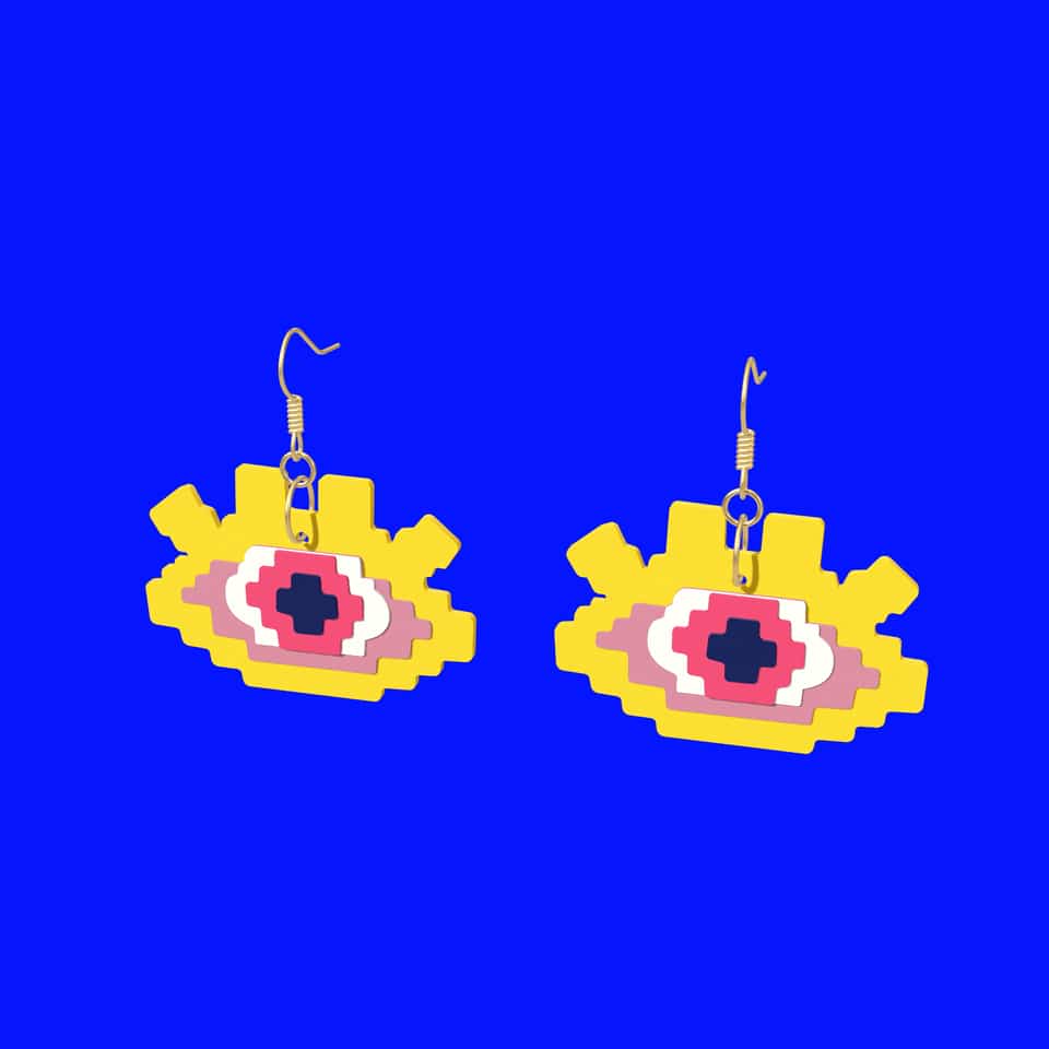 A finished drop earring with its jump ring through the hanging hole and ear-wire loop.