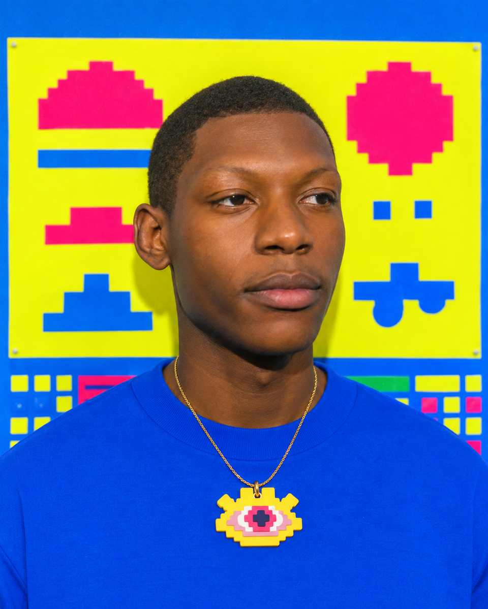 A layered Pixel Eye pendant worn on a gold chain. The guide covers a glued rear bail or a jump ring through a drilled hole.