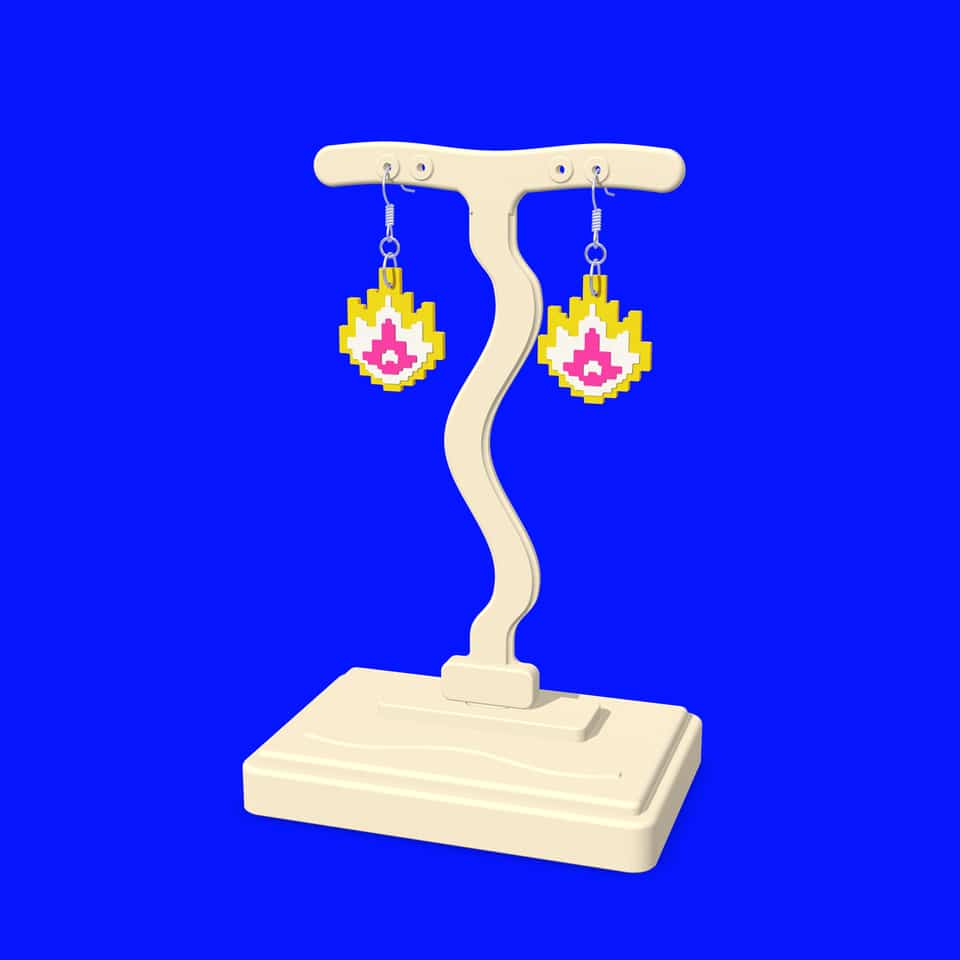 Pixel Flame drop earrings hanging from a printed T-bar display stand.