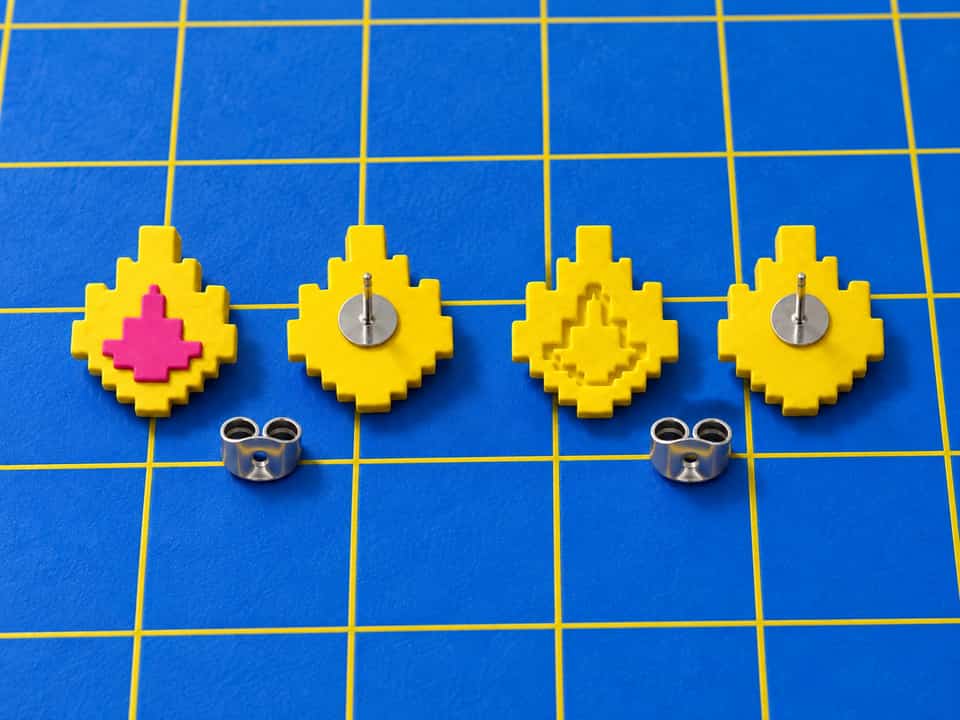 Layered and one-slab relief Pixel Flame studs, shown front and back with their posts. A flat-pad post glues to each flat back.