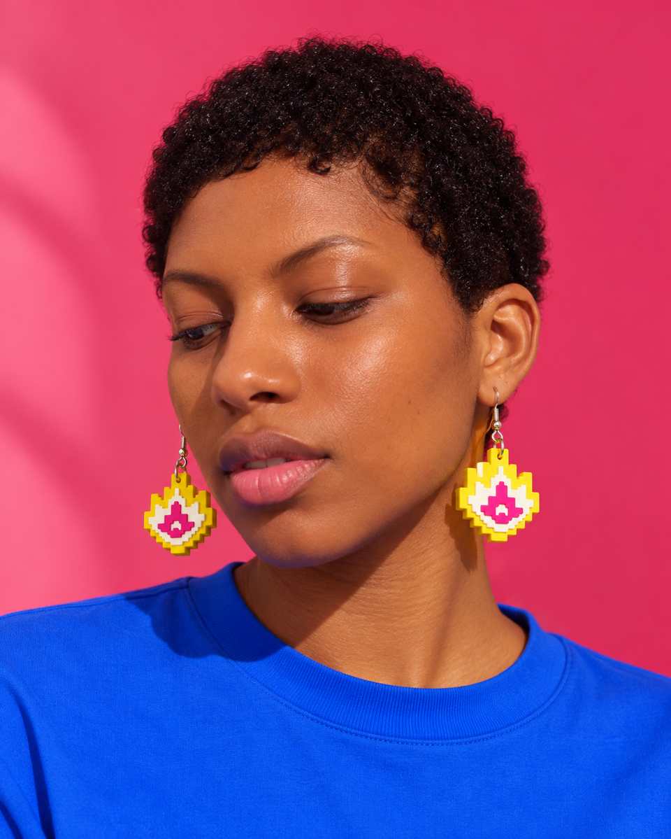 A matching pair of yellow, white and magenta flame drops on ear wires.