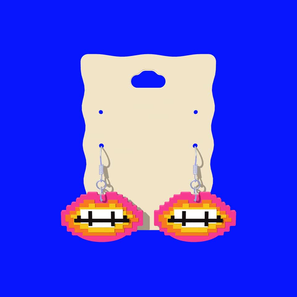 Pixel Lips drop earrings hanging on a printed earring display card.