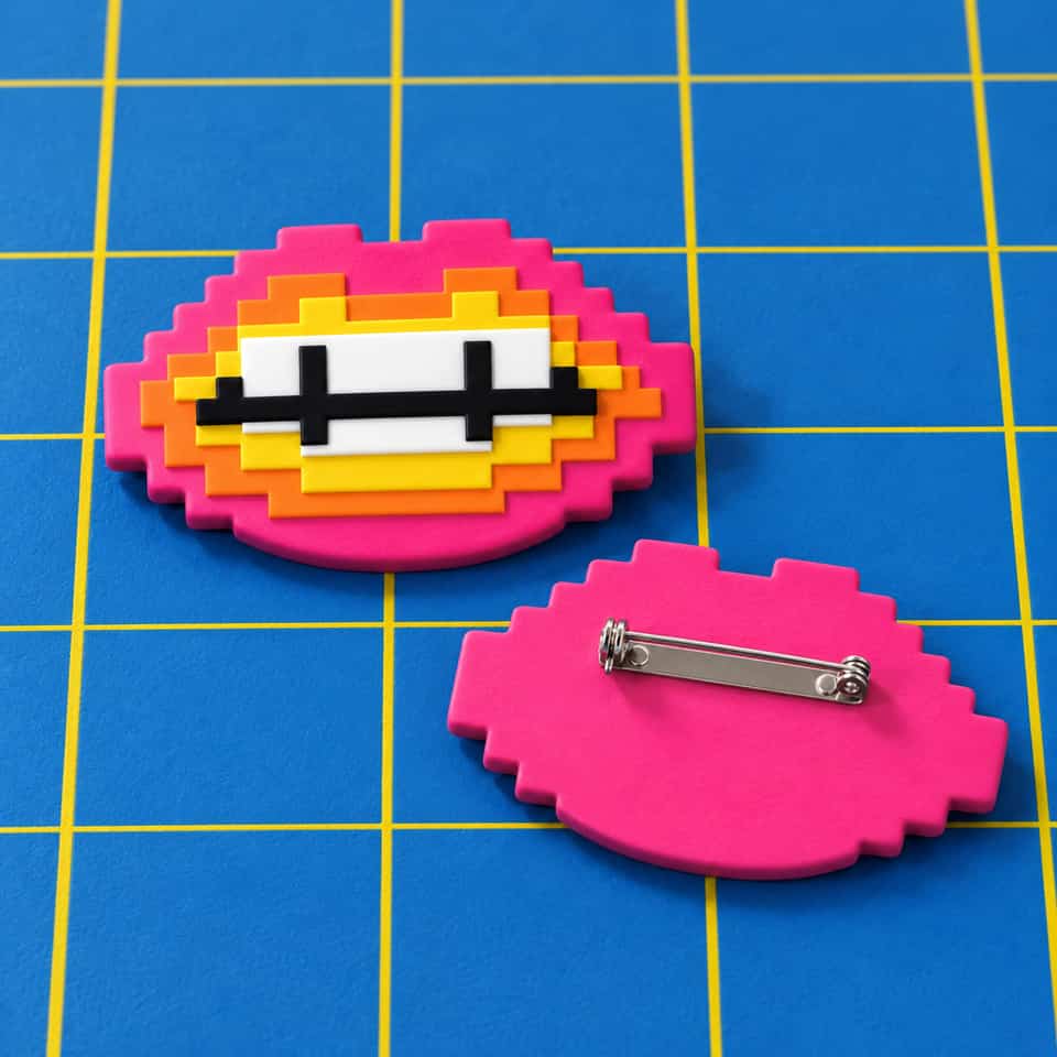 A 56 mm layered Pixel Lips brooch with a pin glued to its flat back.