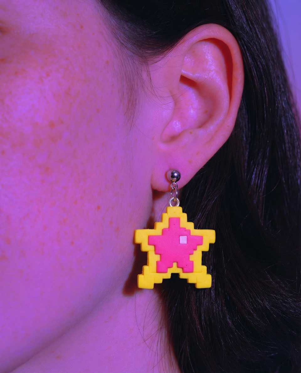 Hot Pink Polymer Clay Pixel Star Dangle Earrings shown in styled wear context with size, drape, and hardware visible. Handmade earrings using pixel construction with a sanded buff…