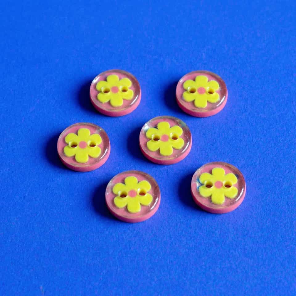 Pink Polymer Clay & Yellow Flower Dome Button Set. Button made with surface effects with a gloss sealant finish. Center a yellow daisy with a tiny pink dot on a flat pink sew-thro…