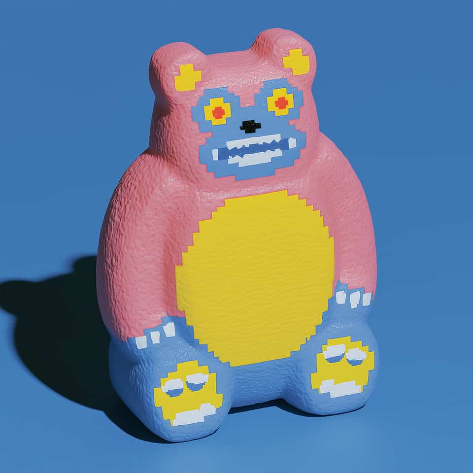 Seated coral-pink polymer clay bear figurine with a coarse pebbled texture and cornflower-blue legs and feet, a stepped blue pixel face mask with yellow square eyes, red centres,…