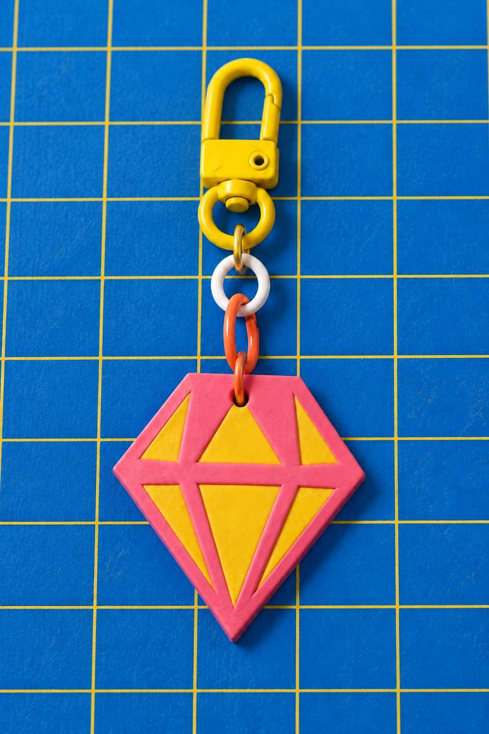 A layered Faceted Gem charm hanging from a swivel clasp.