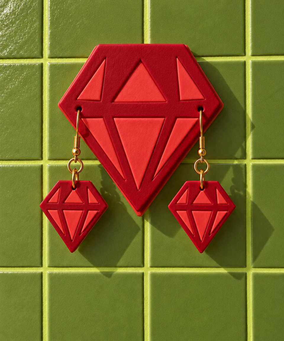 A red and coral wall display with matching drop earrings. Colours and room styling are examples; follow the guide for mounting.