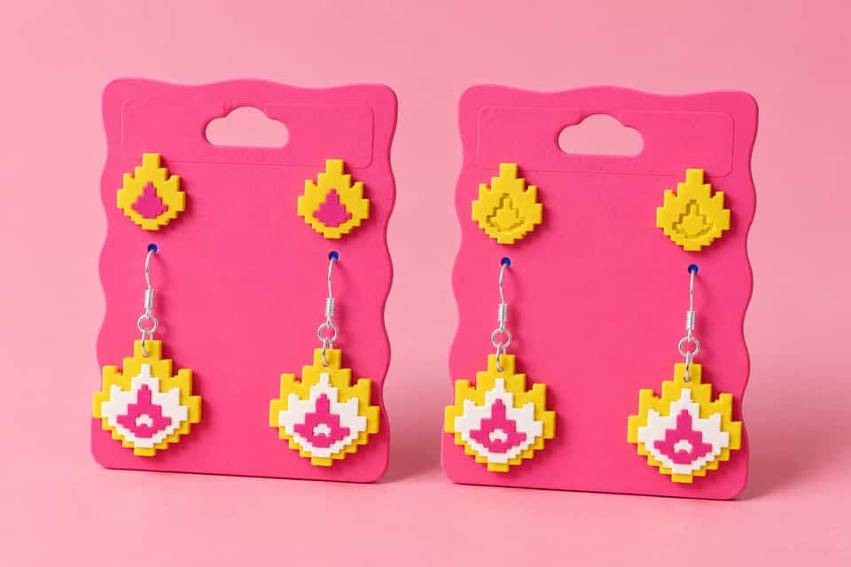 Layered and relief Flame studs above matching layered dangle pairs on pink backing cards.