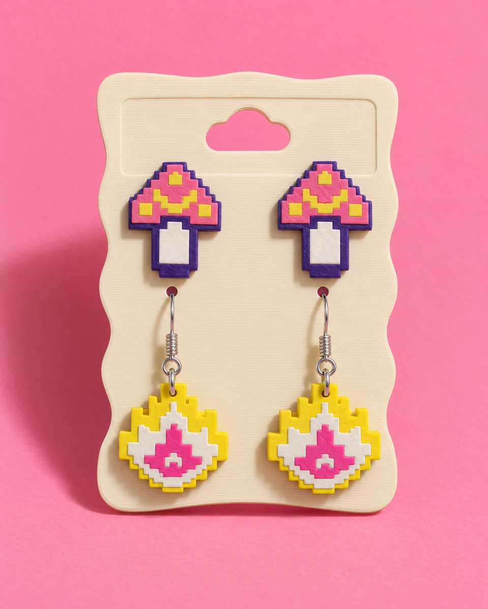 Pixel Mushroom studs above Pixel Flame drops on a printed display card. The Flame drops are a separate kit.