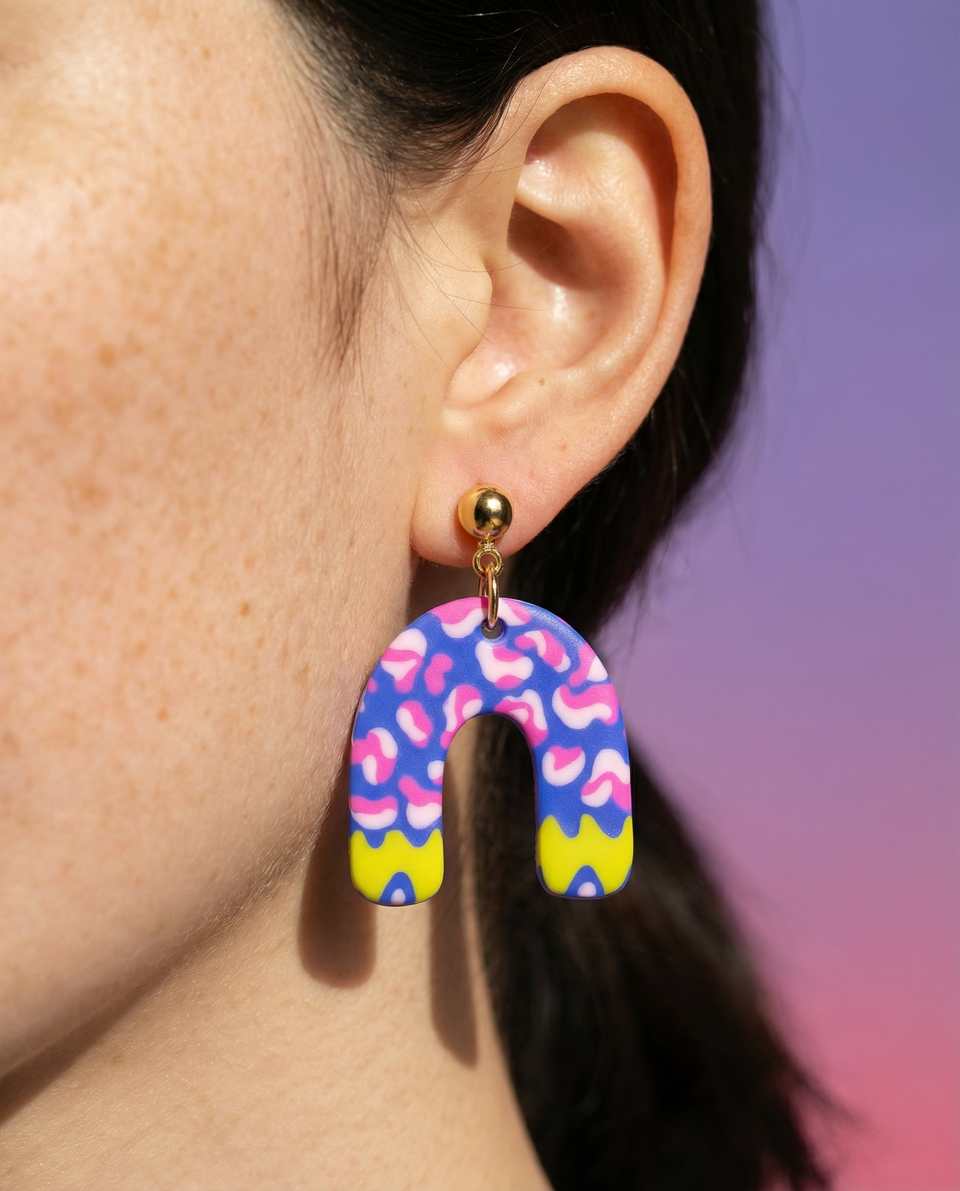 Polymer Clay Abstract Cobalt Squiggle Arch Dangle Earrings shown in styled wear context with size, drape, and hardware visible. Handmade surface applique earrings with gloss seala…