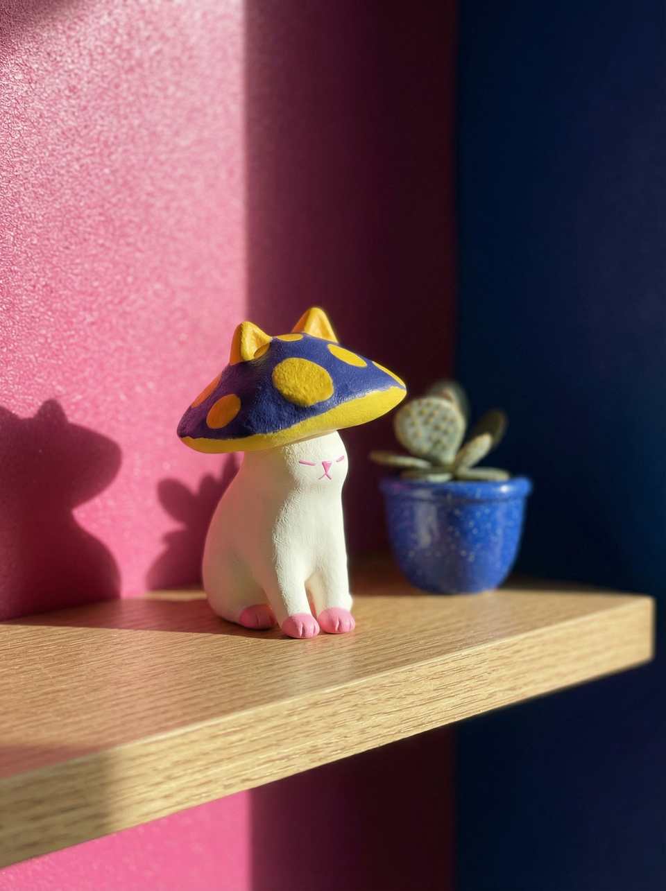 Blue Polymer Clay Spotted Mushroom Cap Cat Desk Buddy Figurine shown in styled display context with object size and surface texture visible. Figurine handmade in sculpting with sa…