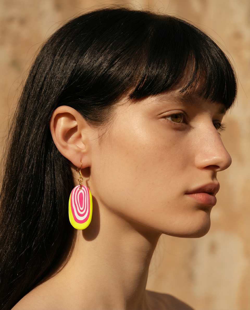 Polymer Clay Neon Bullseye Cane Oval Dangle Earrings shown in styled wear context with size, drape, and hardware visible. Earrings handmade in cane slice with matte sealant finish.