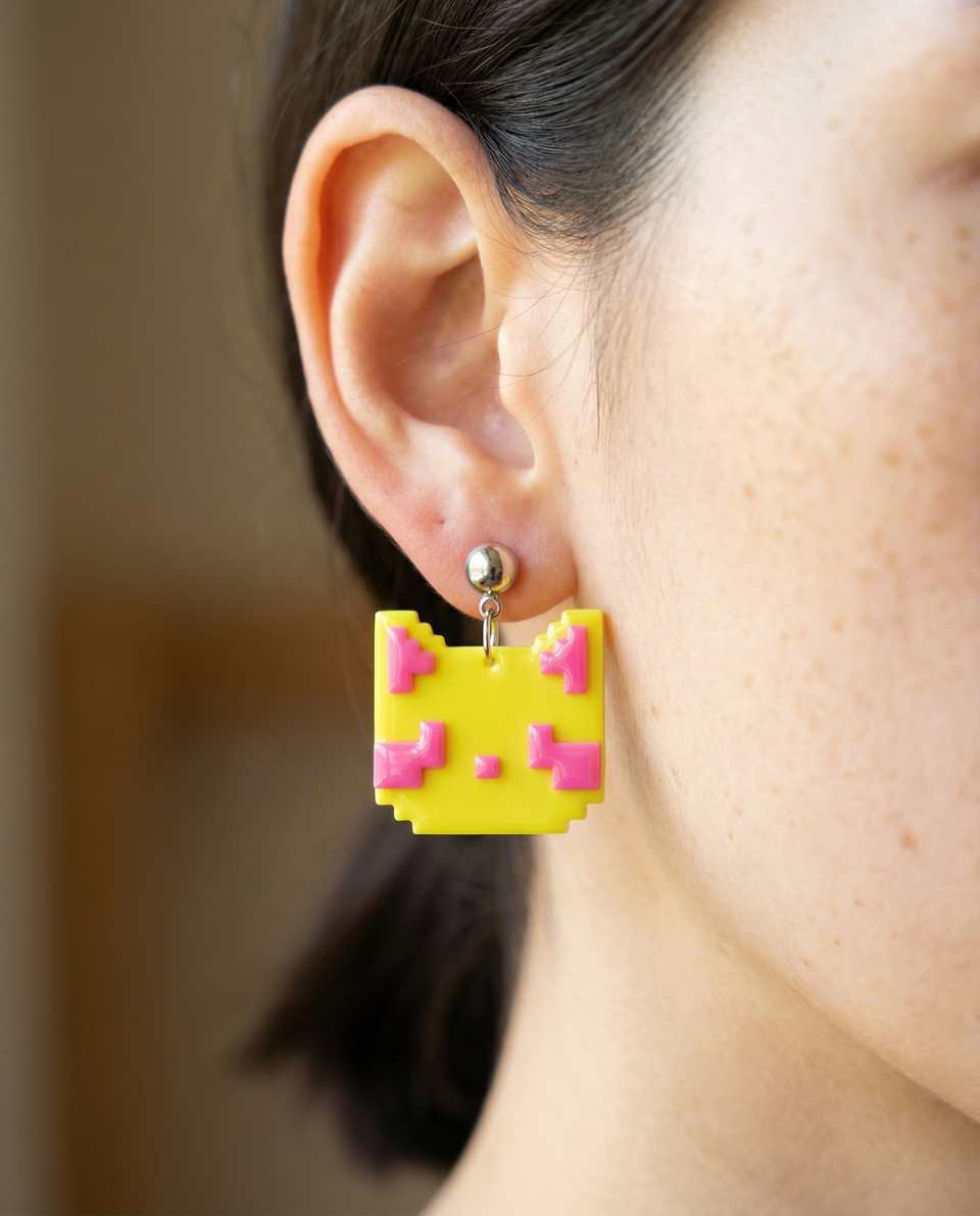Yellow Polymer Clay & Pink Pixel Cat Tile Dangle Earrings shown in styled wear context with size, drape, and hardware visible. Handmade pixel construction earrings with gloss seal…