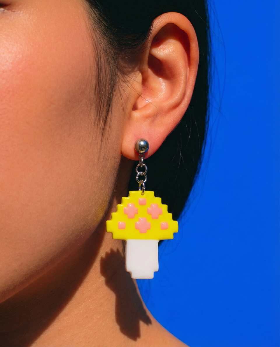 Yellow Polymer Clay Pixel Mushroom Dangle Earrings shown in styled wear context with size, drape, and hardware visible. Earrings handmade in pixel construction with sanded buffed…