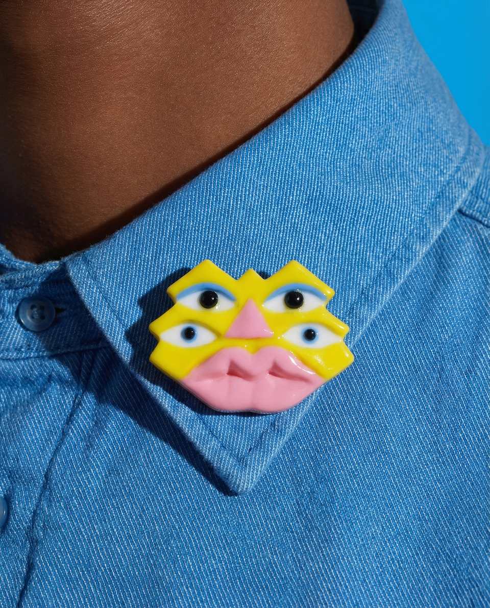 Polymer Clay Four-Eyed Pixel Face Pin shown in styled wear context with size, drape, and hardware visible. Pixel construction brooch, hand-finished with gloss sealant.