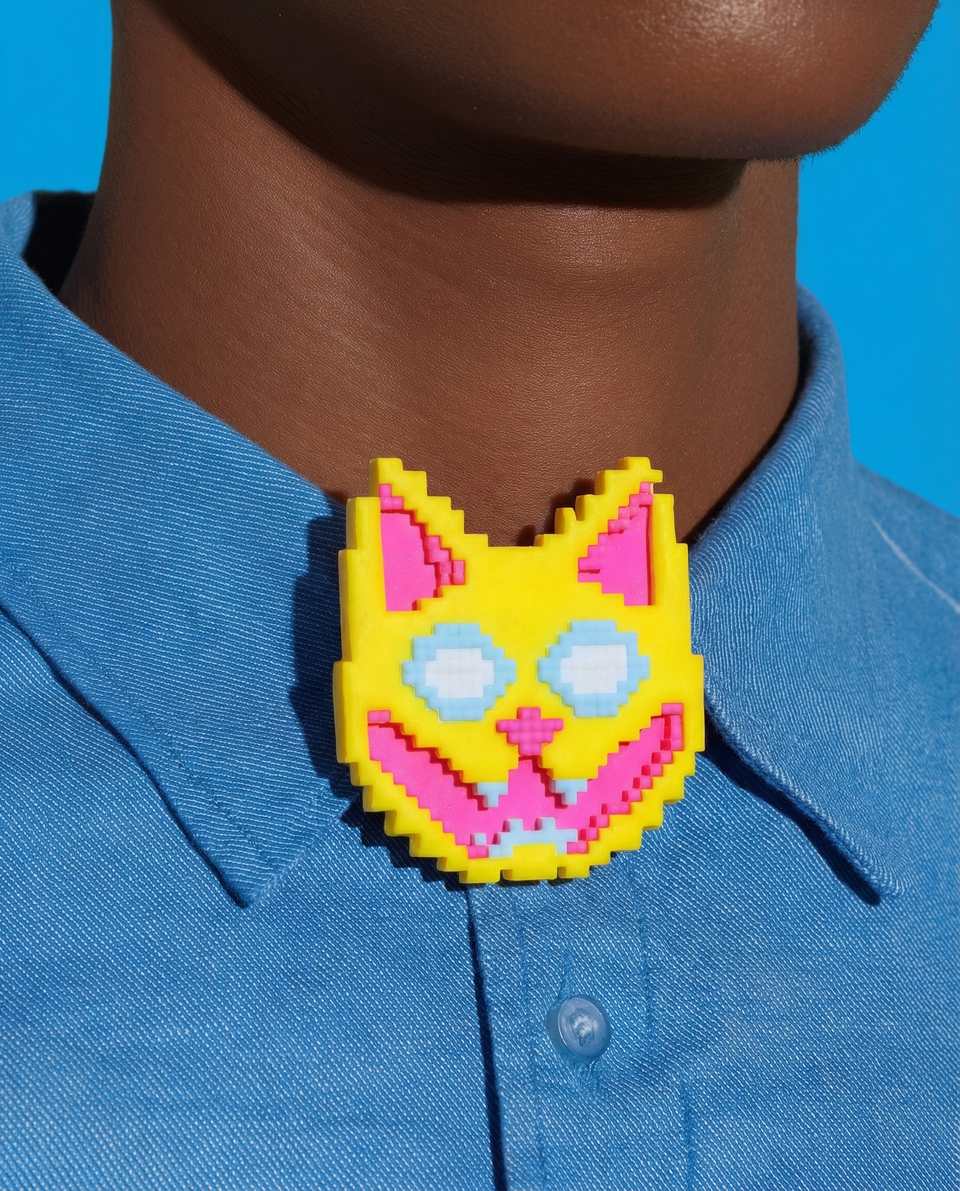 Polymer Clay Grinning Pixel Cat Pin shown in styled wear context with size, drape, and hardware visible. Brooch handmade in pixel construction with gloss sealant finish.