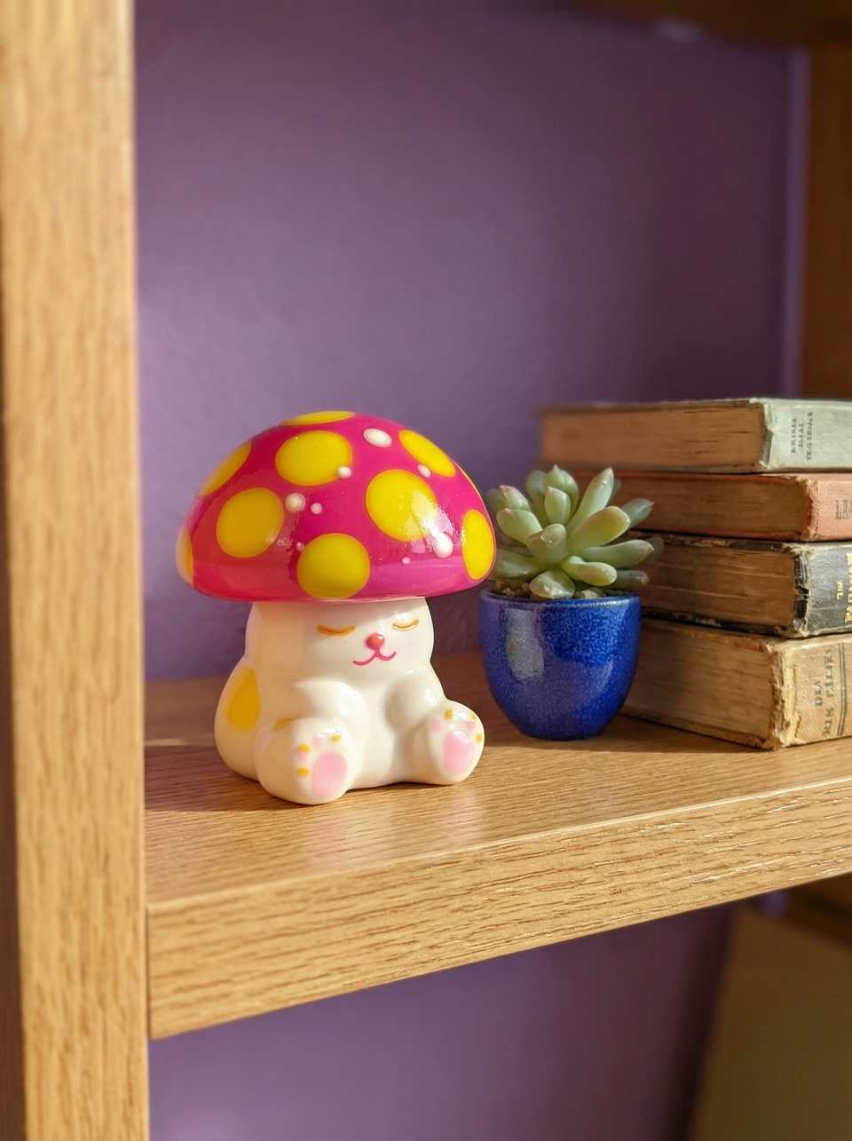 Pink Polymer Clay Mushroom Cap Cat Desk Buddy Figurine shown in styled display context with object size and surface texture visible. Sculpting figurine, hand-finished with light g…