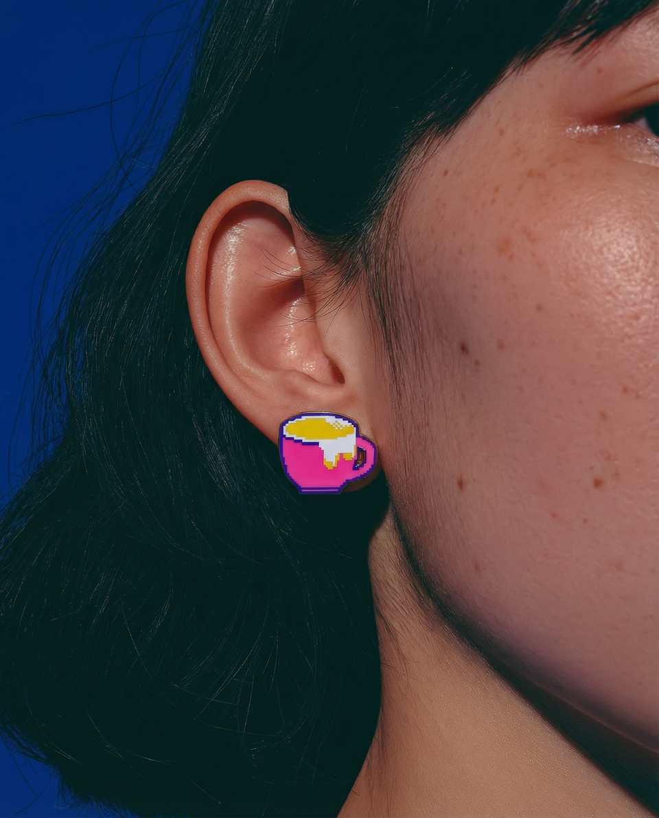 Pink Polymer Clay Pixel Coffee Mug Stud Earrings shown in styled wear context with size, drape, and hardware visible. Pixel construction earrings, hand-finished with gloss sealant.