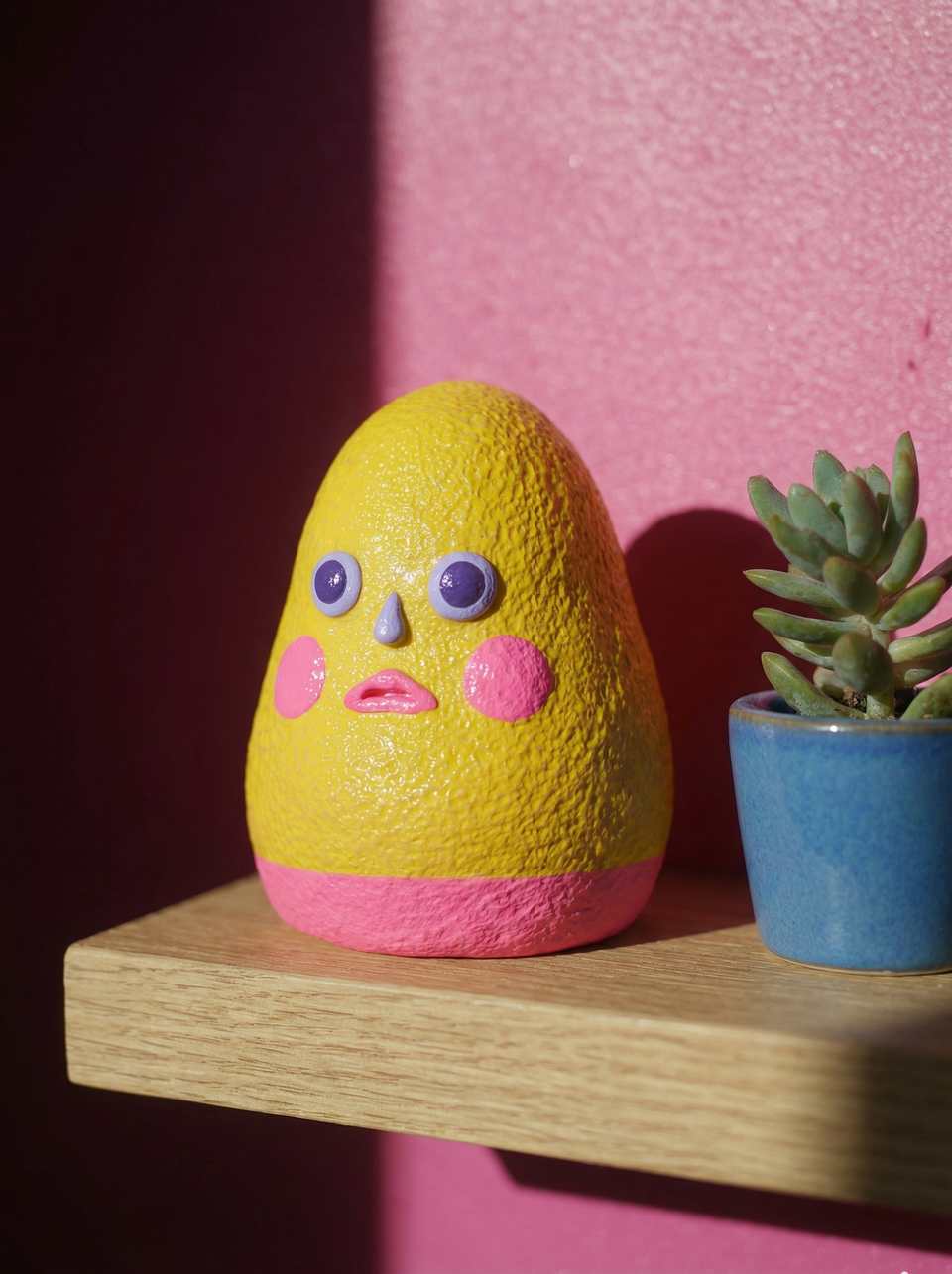 Polymer Clay Textured Yellow & Pink Blob Desk Pet Figurine shown in styled display context with object size and surface texture visible. Handmade sculpting figurine with satin fin…
