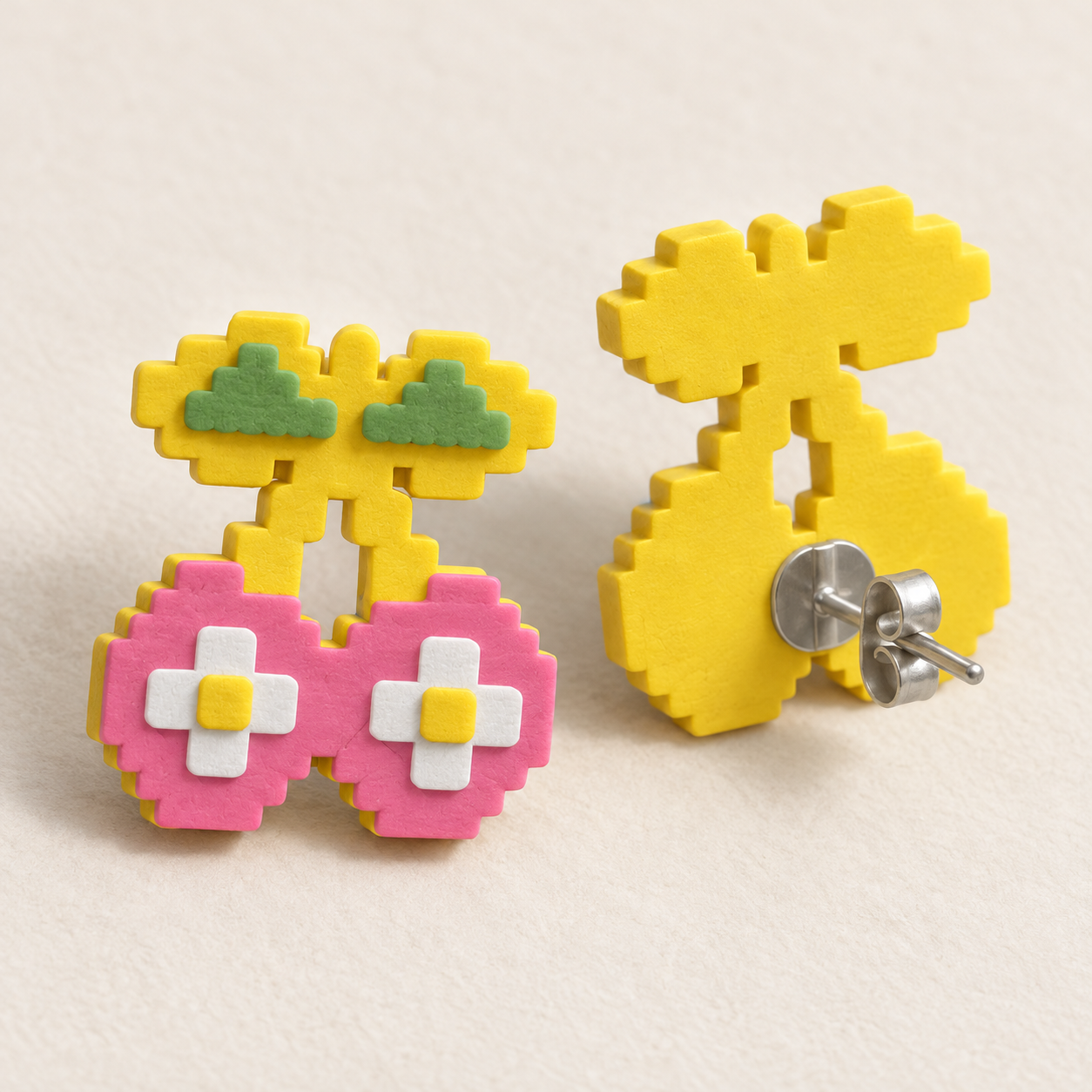 A Cherry stud shown from the front beside a rear view with its metal post and butterfly backing visible.